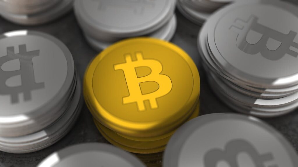 Golden and silver Bitcoin coins in a close-up shot, symbolizing cryptocurrency and digital money.
