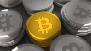Golden and silver Bitcoin coins in a close-up shot, symbolizing cryptocurrency and digital money.