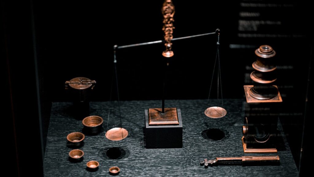a display case with a scale, cups, and other items