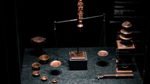 a display case with a scale, cups, and other items