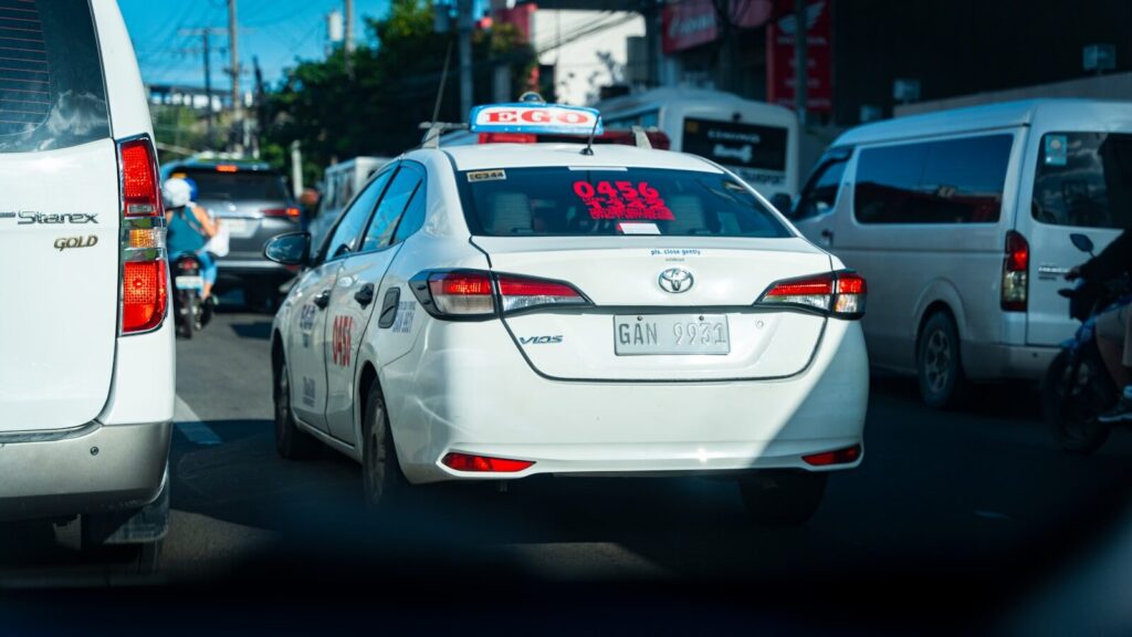 a white car with an alarm clock on the back of it