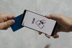 A person holding a cell phone in their hand