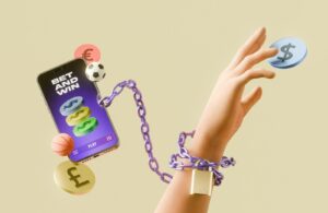 Gambling addiction concept with hand chained to a betting app.