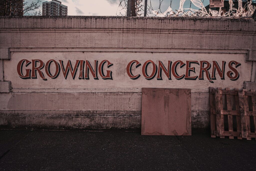 a sign on the side of a building that says growing concerns