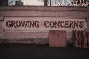 a sign on the side of a building that says growing concerns