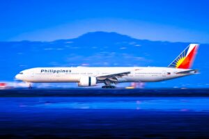 Philippine airlines airplane on runway at dusk