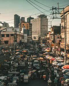 Crowded street scene in Manila, showcasing urban life and traffic.