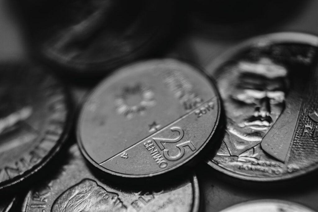 Detailed view of assorted coins highlighting different denominations in monochrome.