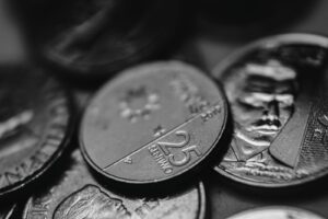 Detailed view of assorted coins highlighting different denominations in monochrome.