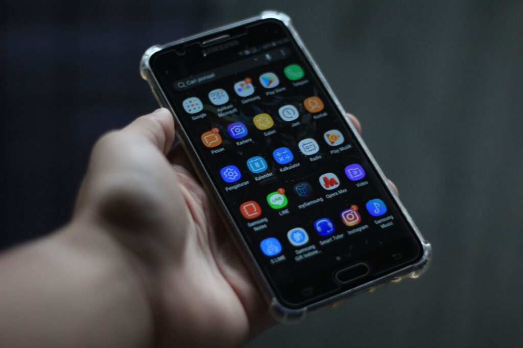 Close-up of a smartphone showcasing various mobile applications on its display.