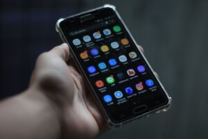 Close-up of a smartphone showcasing various mobile applications on its display.